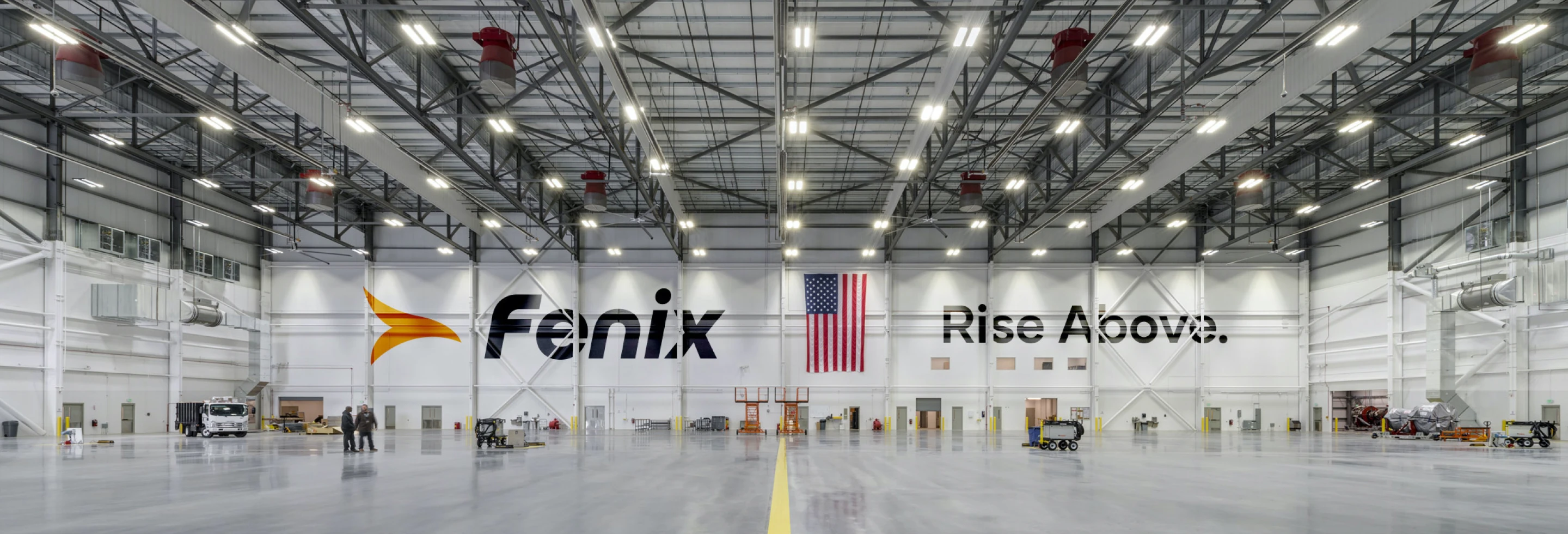 The Fenix Space hangar with 'Rise Above.' painted on the wall