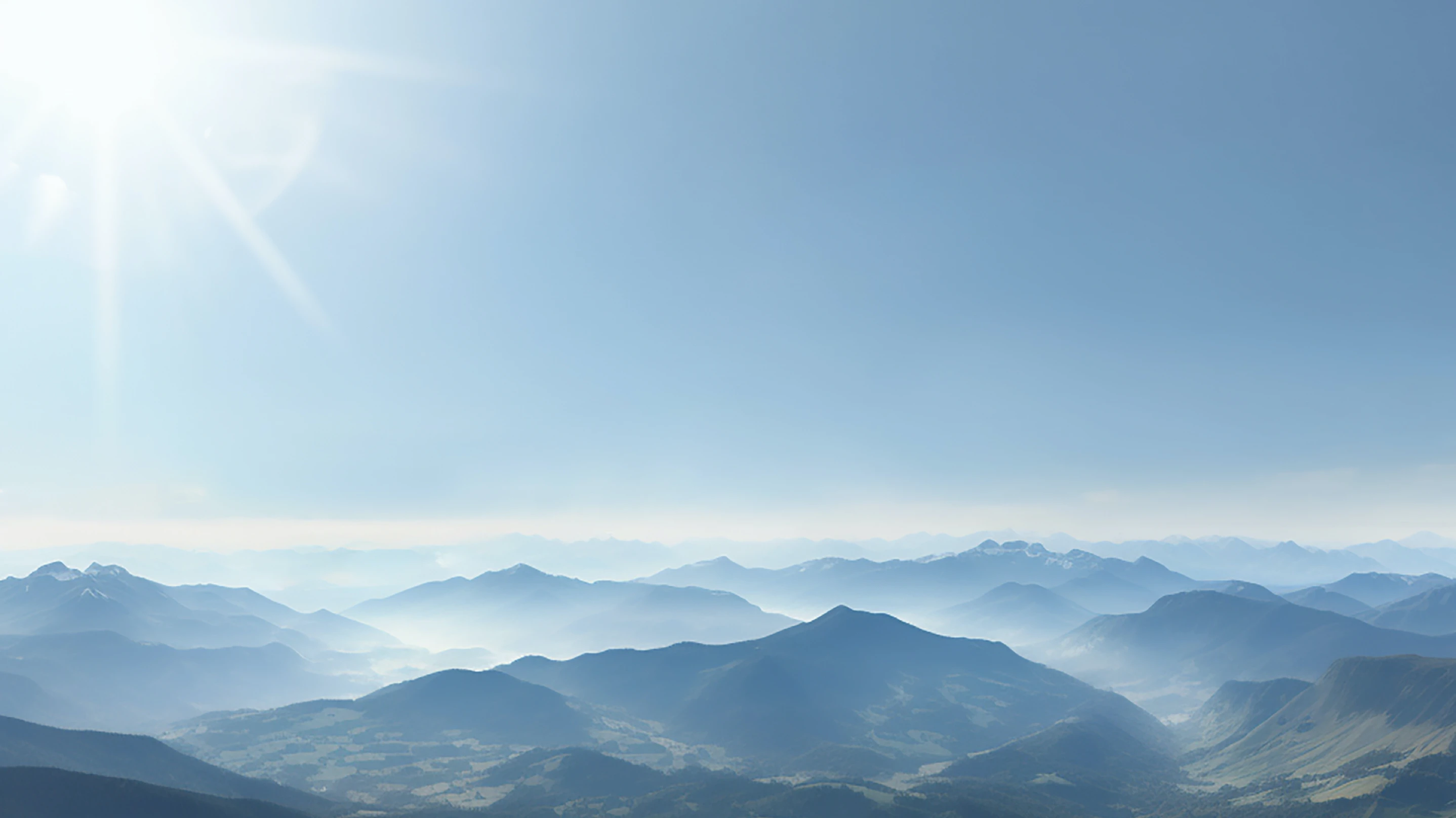 High-altitude blue mountains beneath the flight corridor